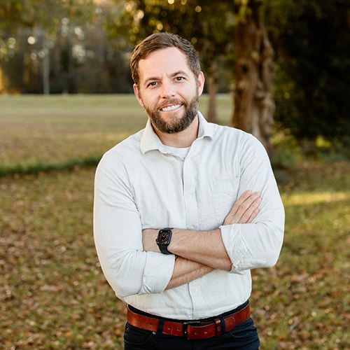 A man in a suit standing outside