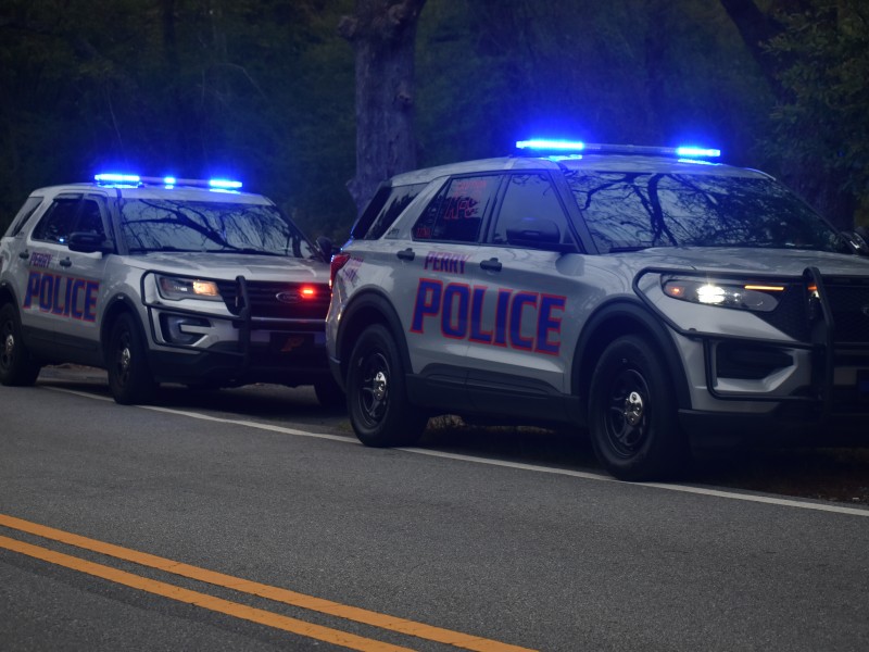 Two Perry Police Department Squad Cars with sirens on