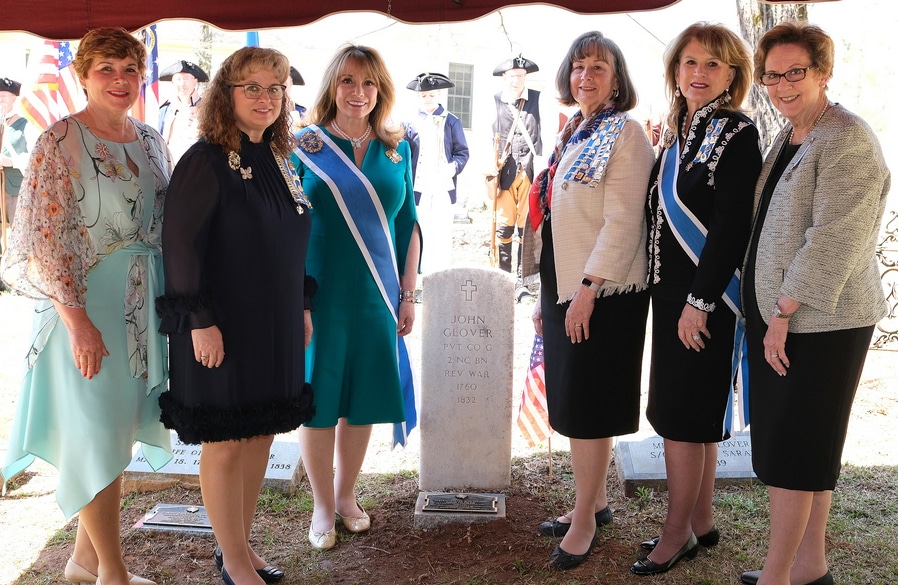 Seven women of the Sukey Hart, Mary Hammond Washington, and Nathaniel Macon Chapters of the Daughters of the American Revolution, along with the President General, Chaplain General, and Georgia State 1st Vice Regent, attend a grave marking ceremony in Lizella Sunday, March 24.