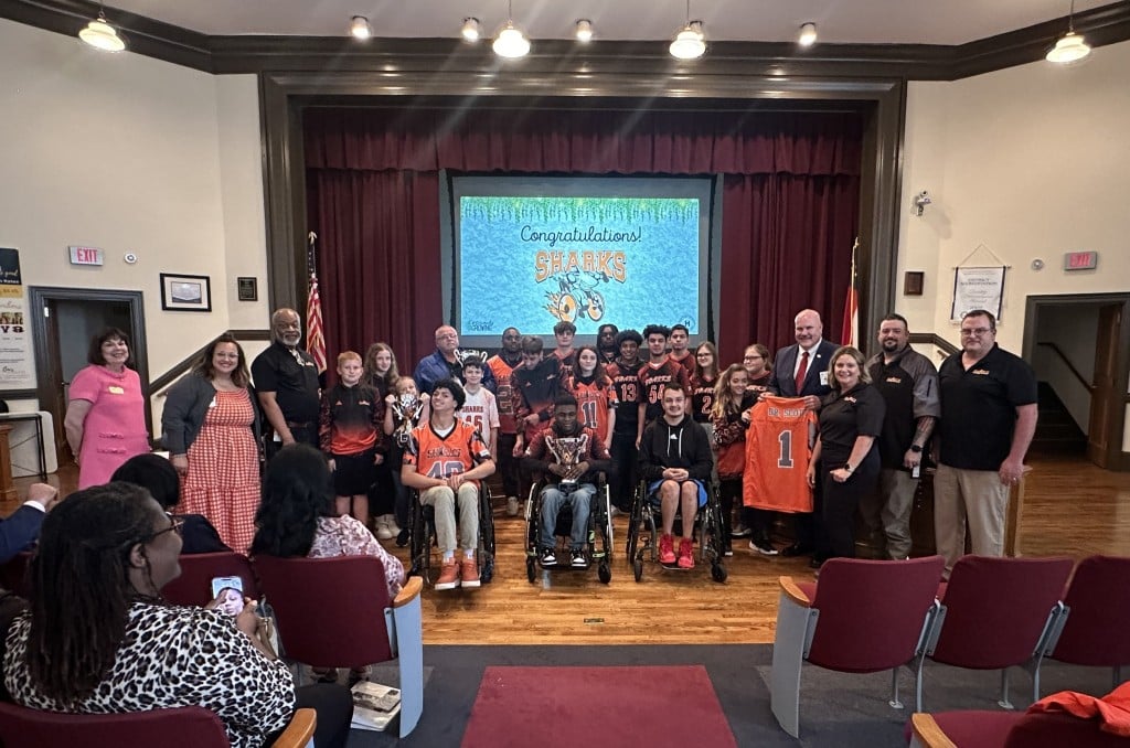 group of students posing for a picture with board members