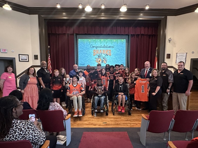group of students posing for a picture with board members