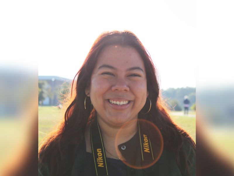 A young woman outside in a field