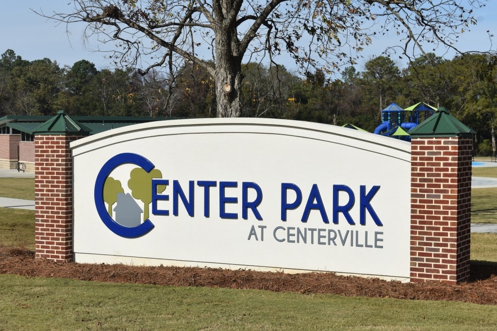 Photo of sign saying Center Park in blue letters and "at Centerville" in gray. 