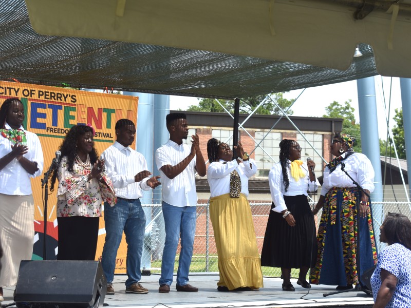 group of African Americans singing and clapping along to a song