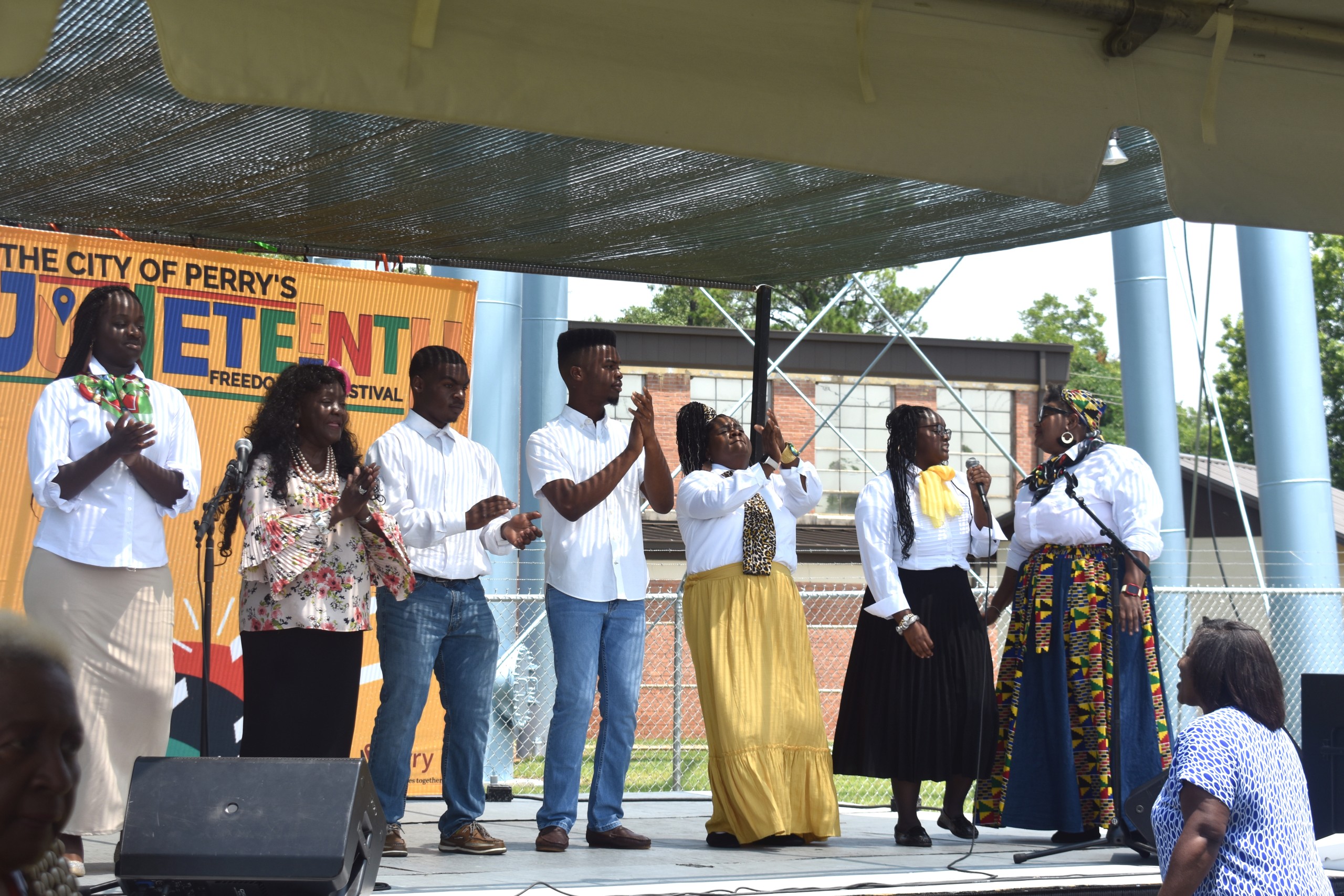 group of African Americans singing and clapping along to a song