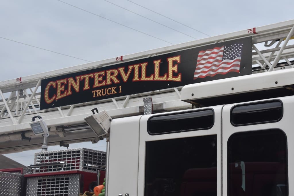 Photo of fire truck with the words "Centerville" in gold.