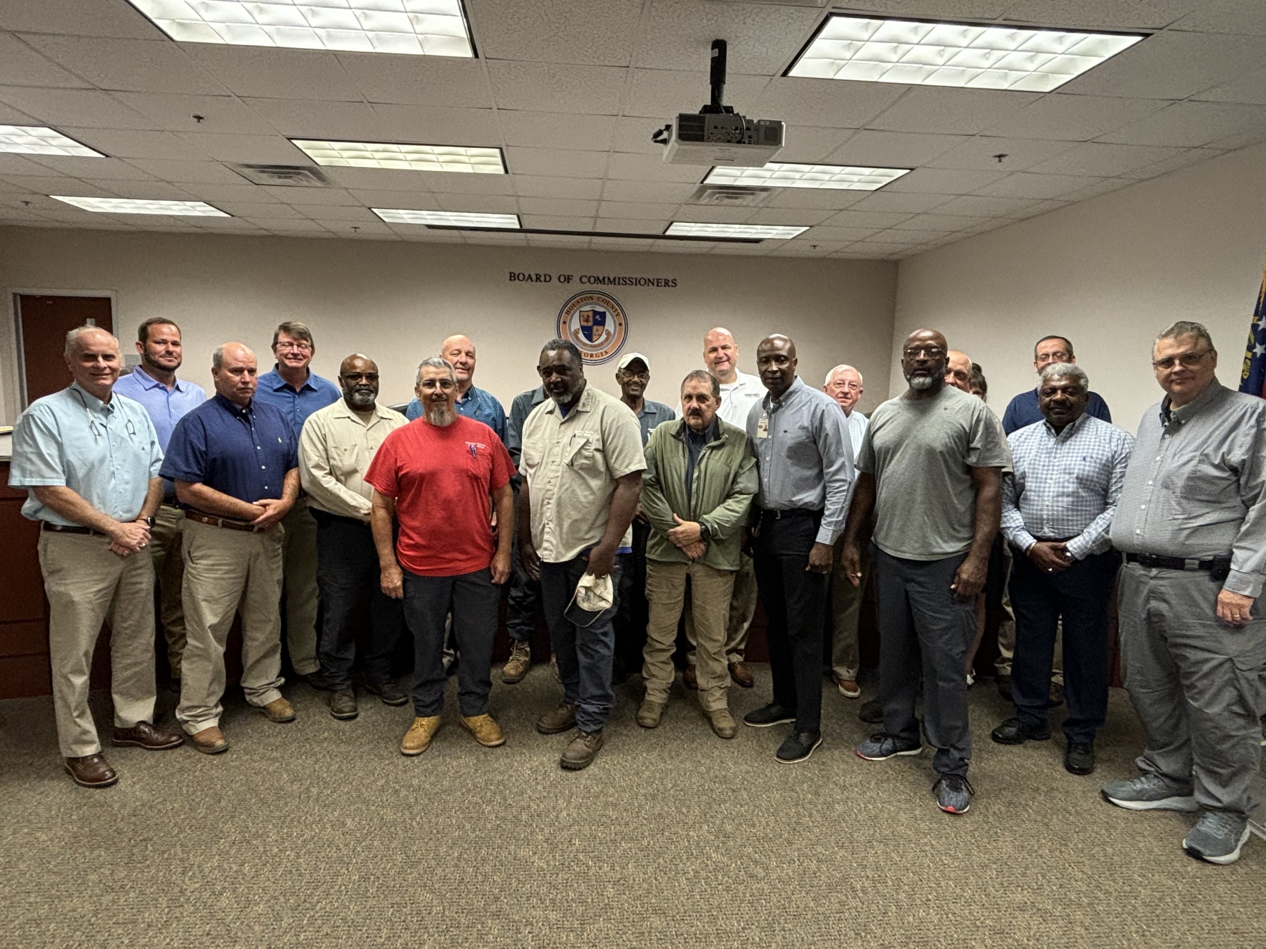 group of people, some who are County Commissioners, others the workers who endured Flood of 1994