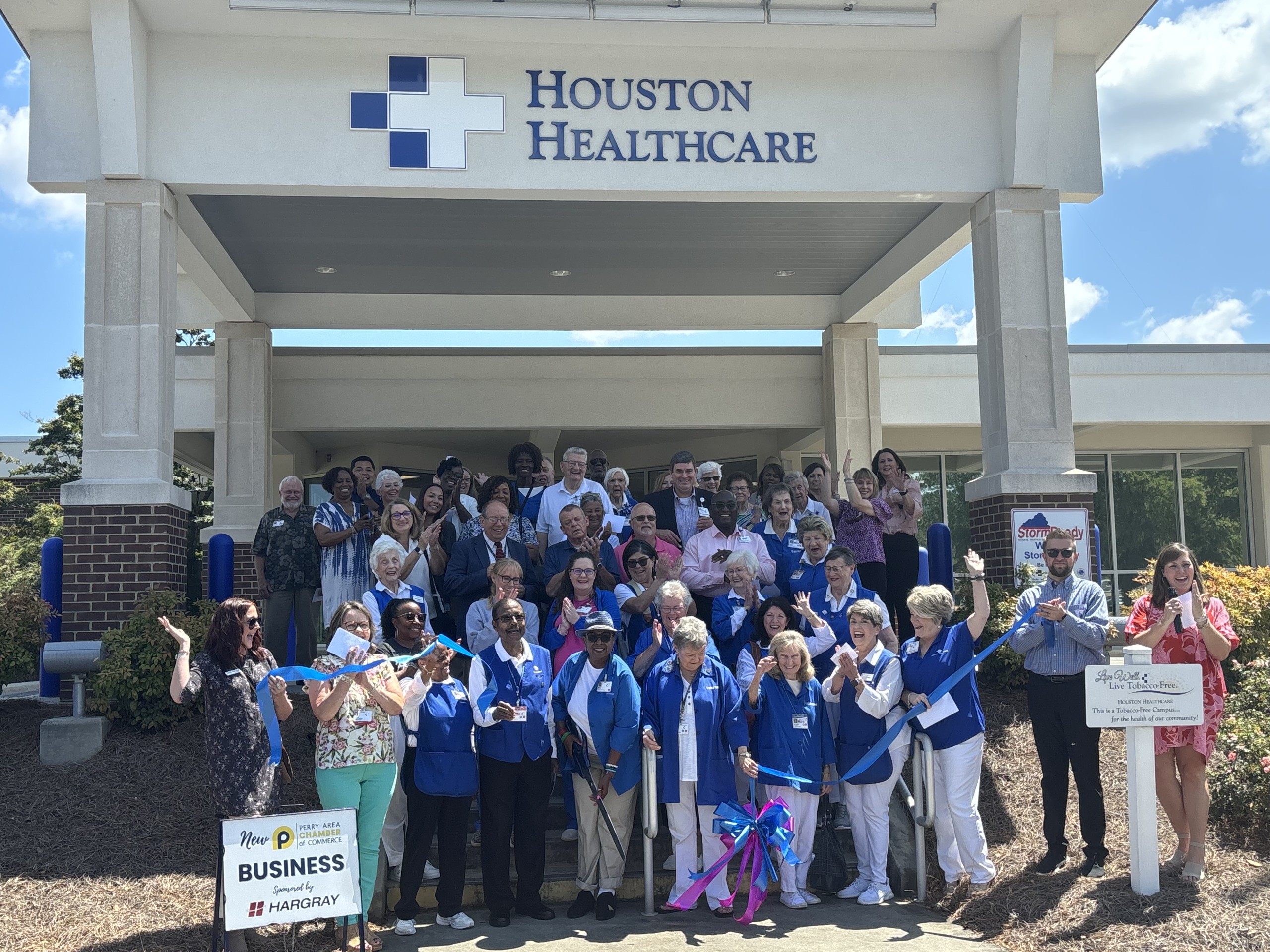 group of people on the steps in front of Houston Healthcare Perry