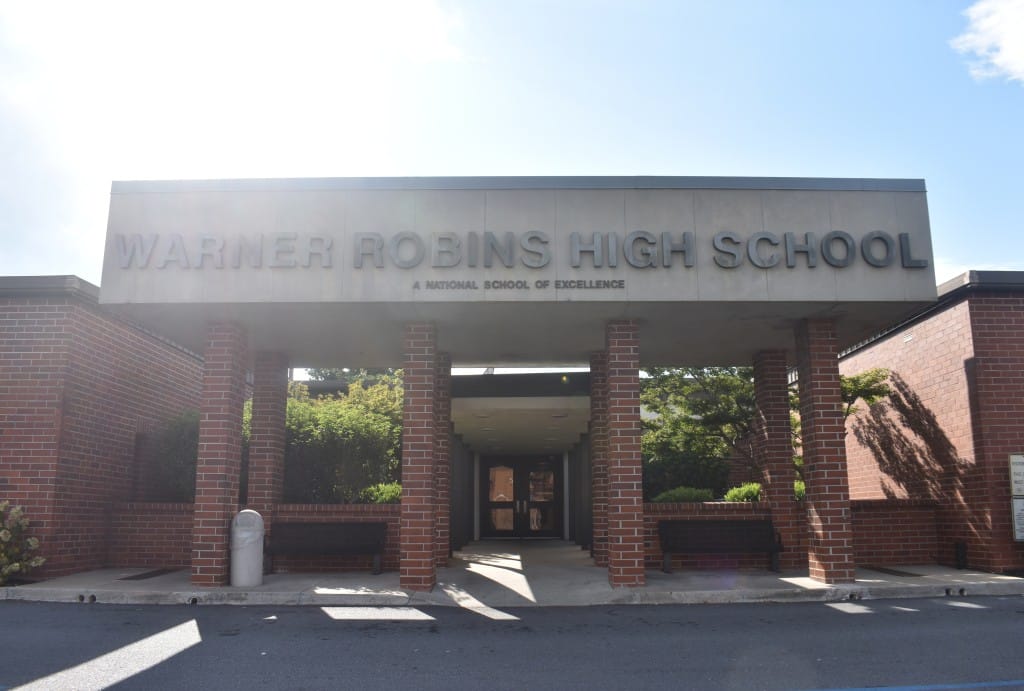 Photo of a bricked building. Letters saying "Warner Robins High School"