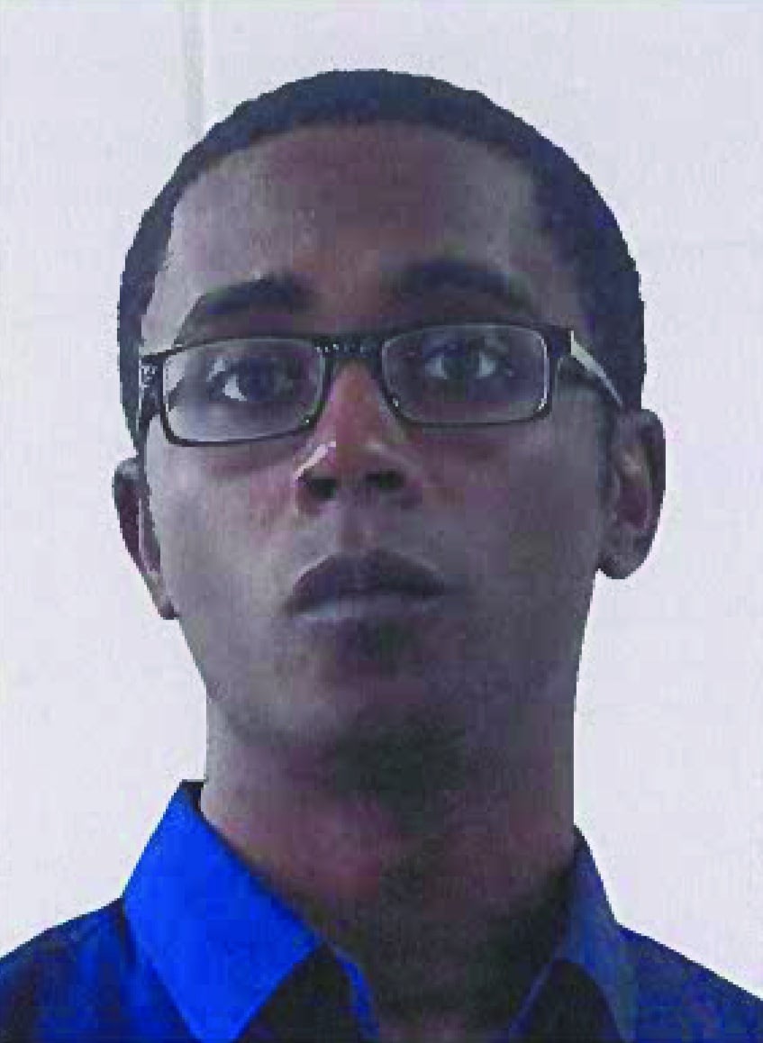 Mugshot of an African American Male wearing glasses and a blue collard shirt