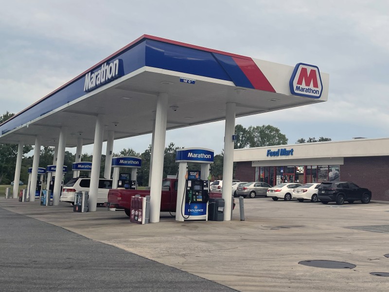 Photo of a blue and white gas station.
