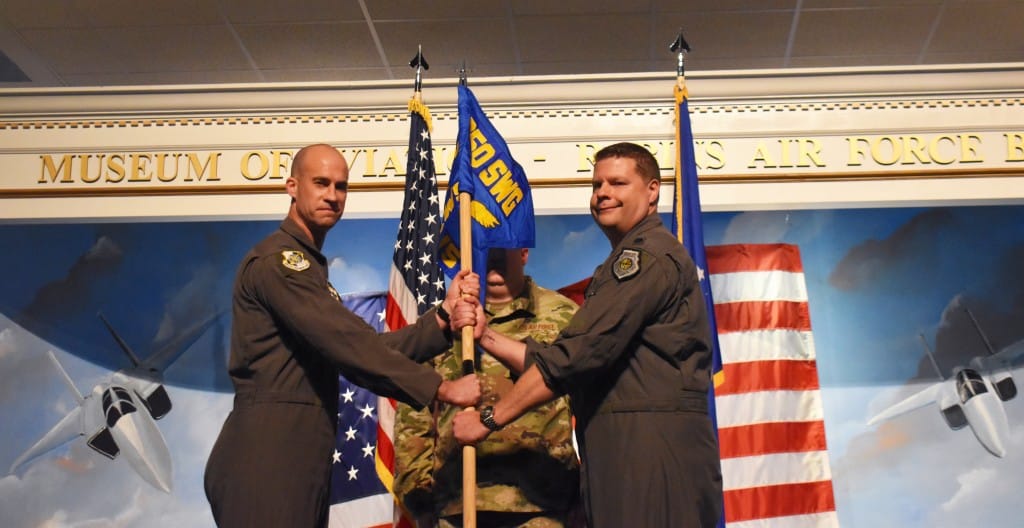 Two men dressed in uniform smiling for the cameras.