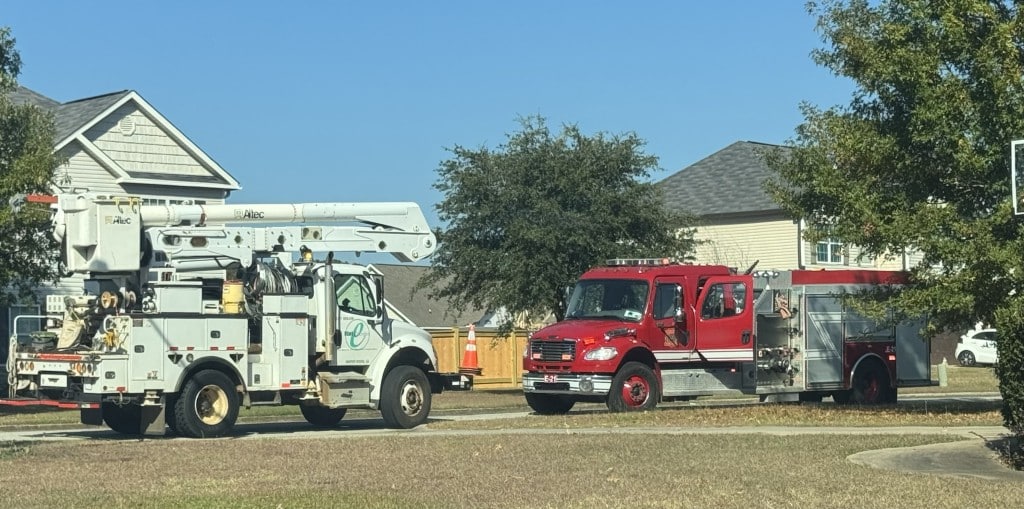 Photo of a flint energies truck and fire truck on the scene.