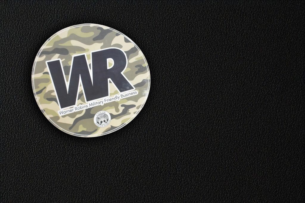 A camouflage sticker that says "Warner Robins Military Friendly Business"