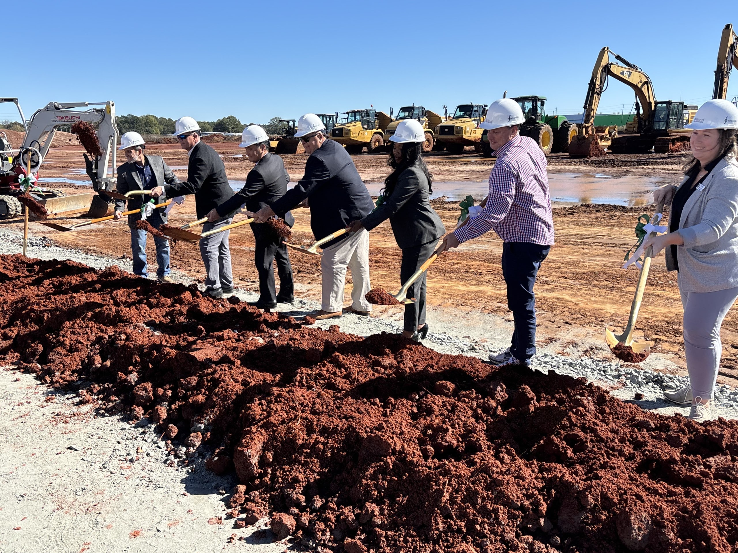 men and women with shovels digging