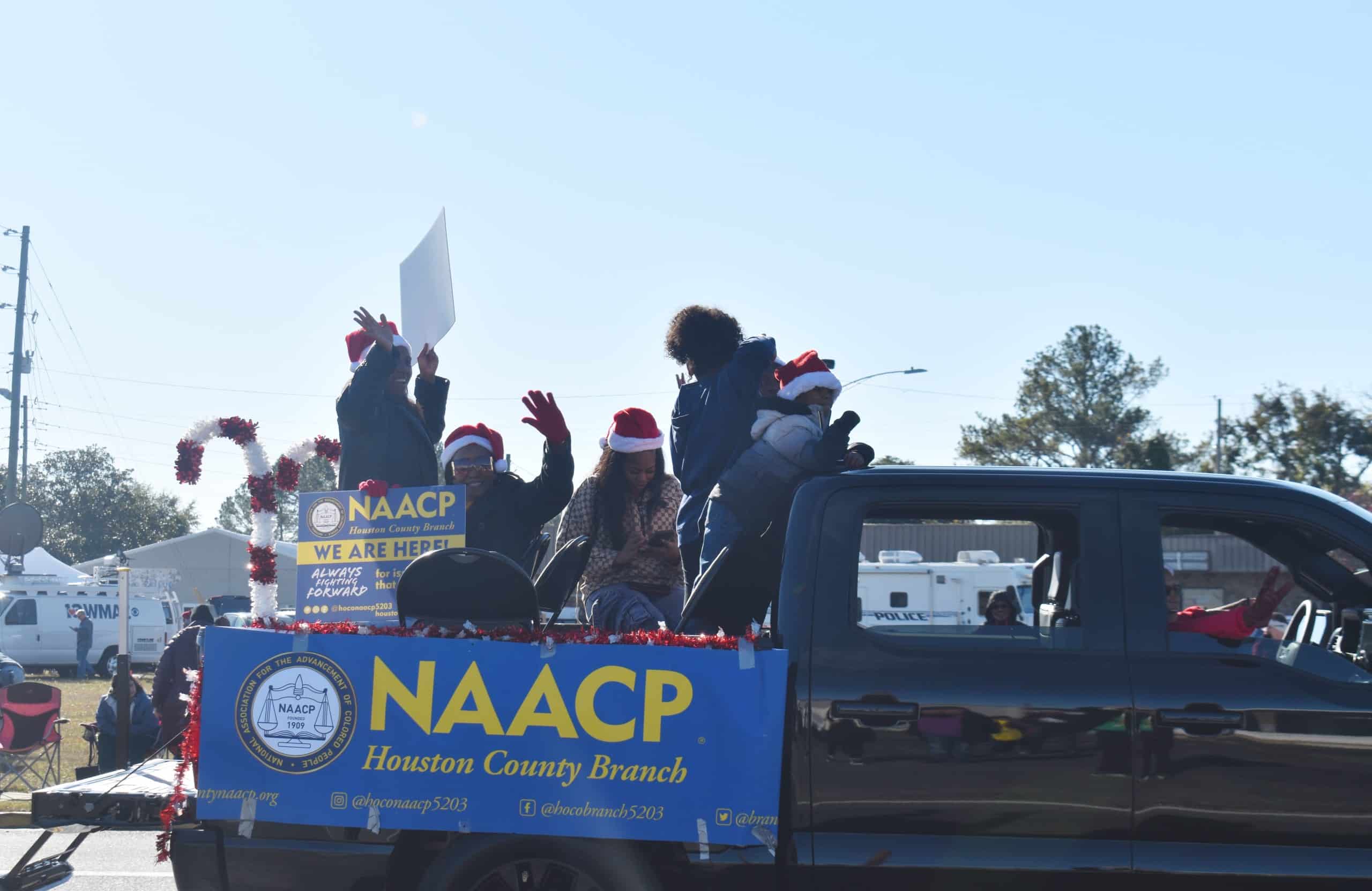 NAACP members waving at the parade crowd.