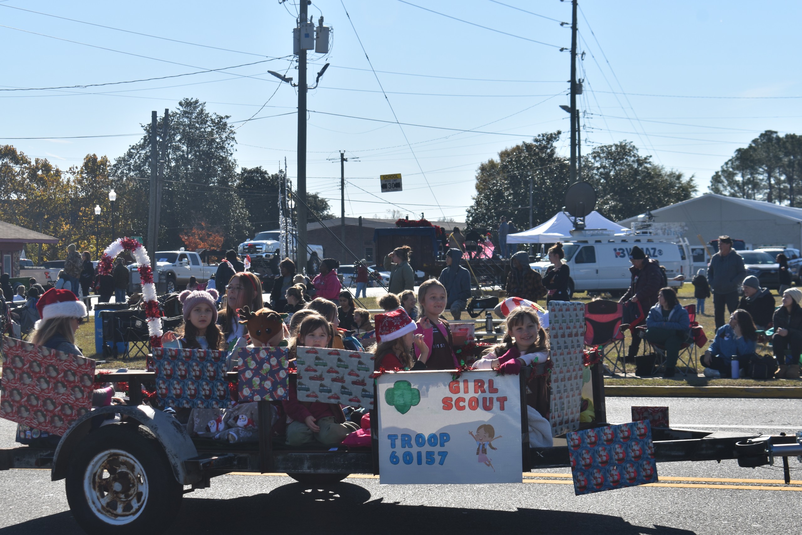 Member of the Girl Scouts sitting on their float watching the crowd.