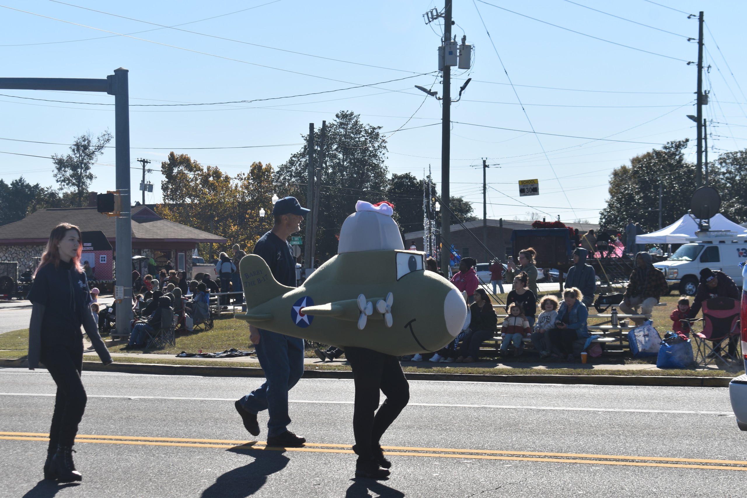 National STEM Academy representative dressed in an airplane costume walking through the parade.