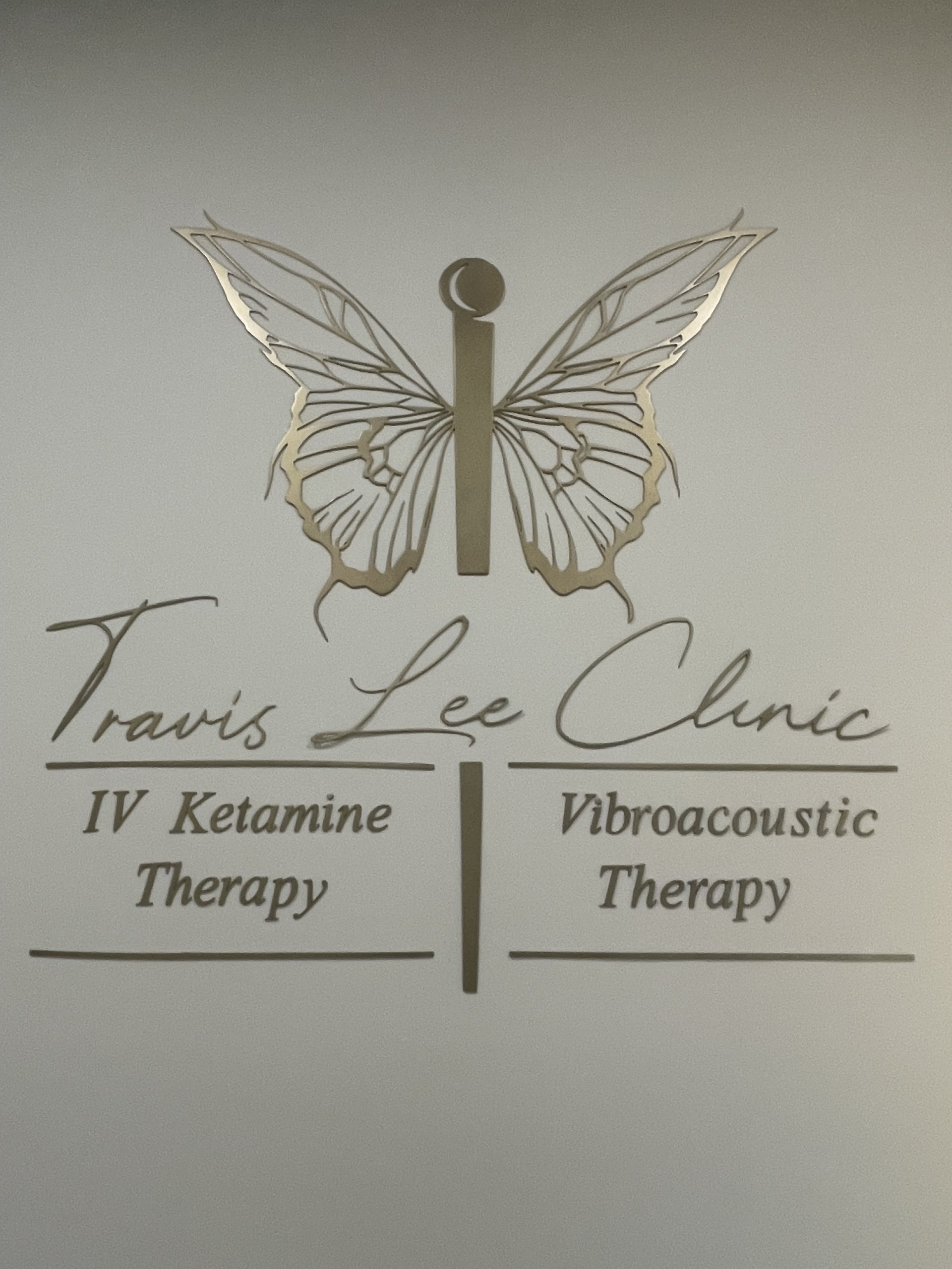 Travis Lee Clinic with the logo of a butterfly