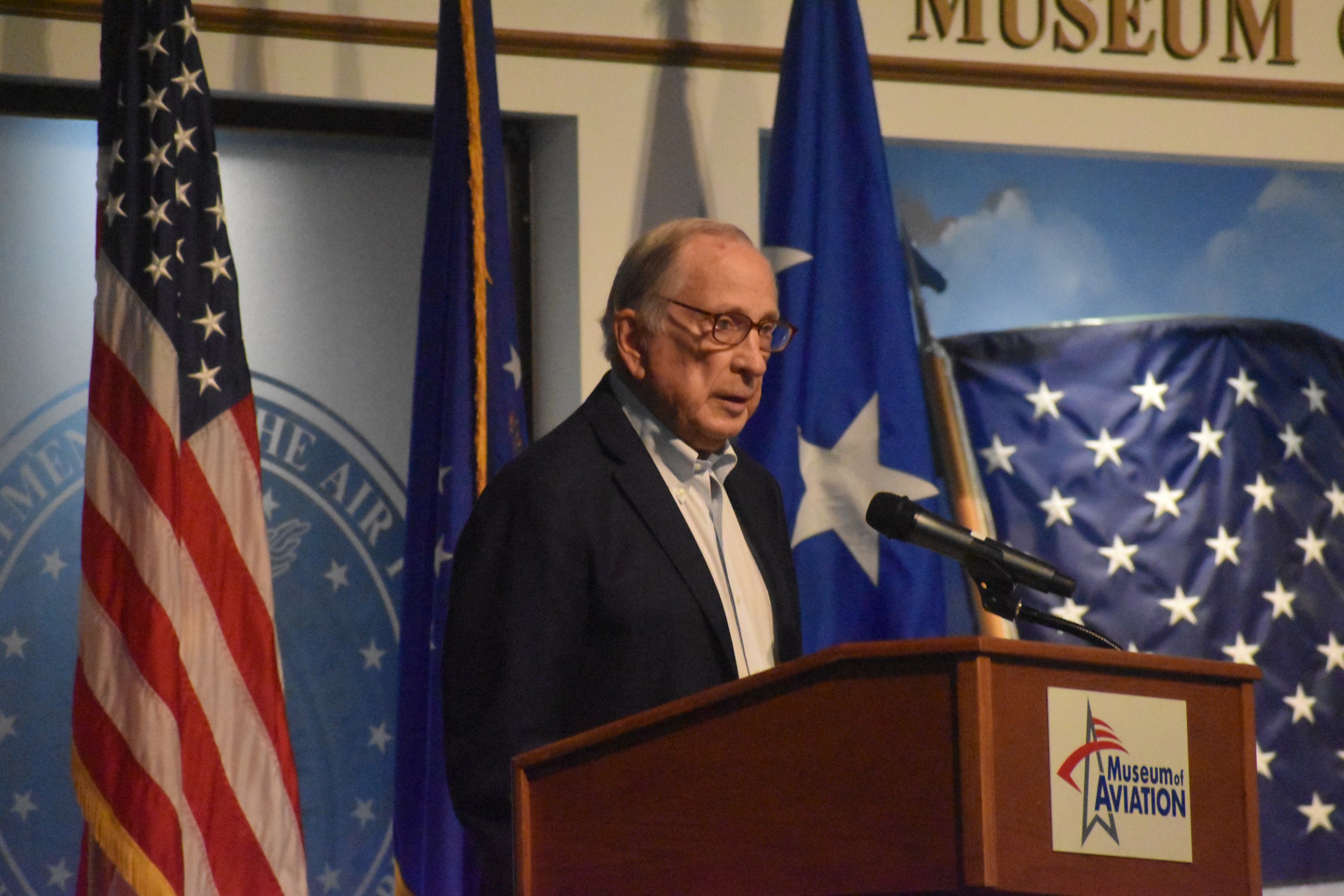 A man speaking behind a podium.