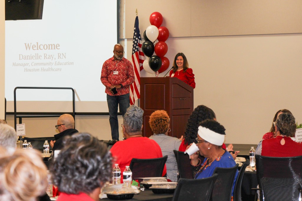 A women behind a podium speaking to an audience.