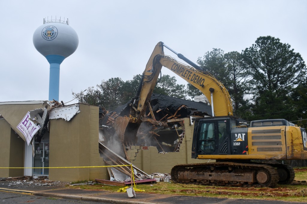 An excavator tearing down a building.