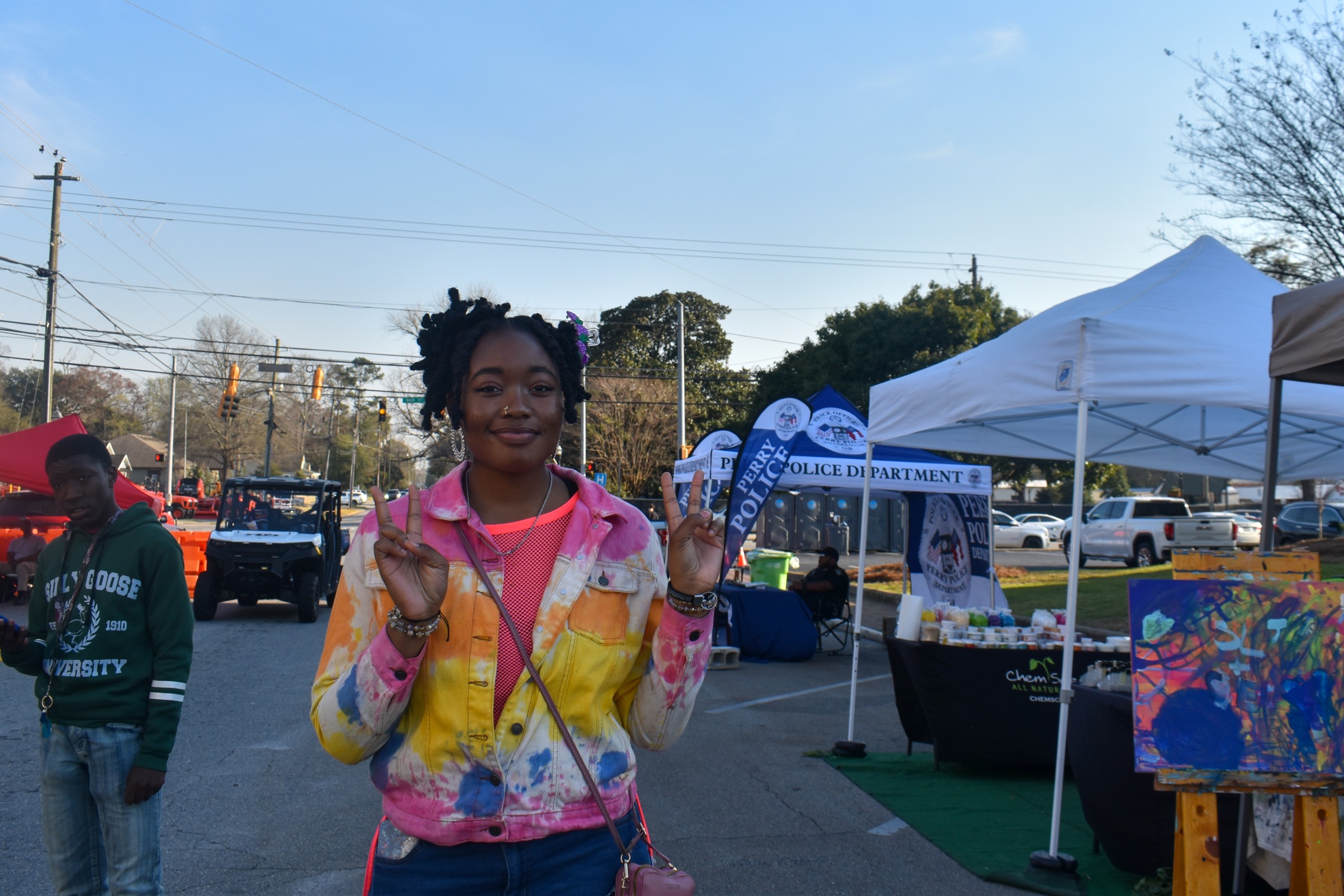 A girl in a tie-dye sweater.
