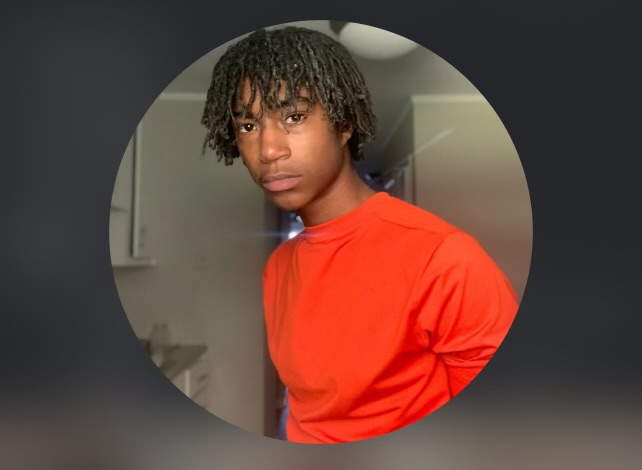 A boy in an orange shirt.