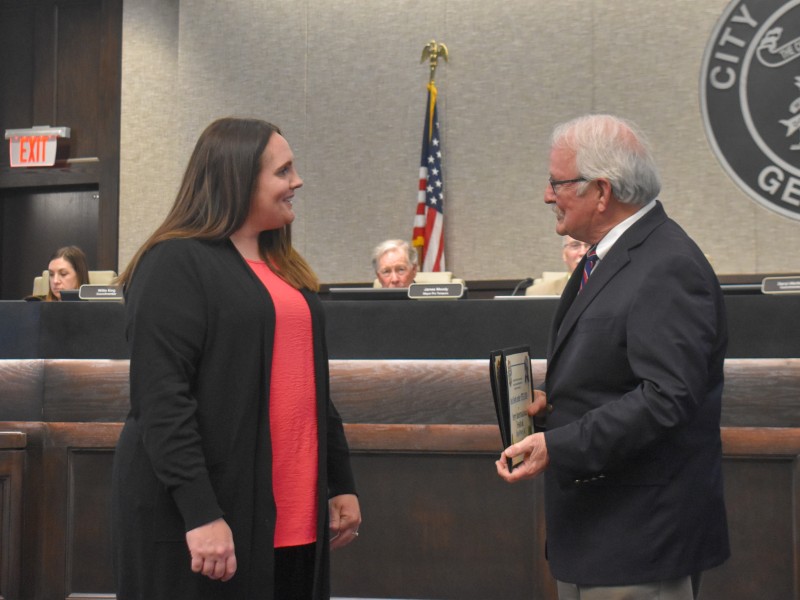 A woman and a man speaking to each other.