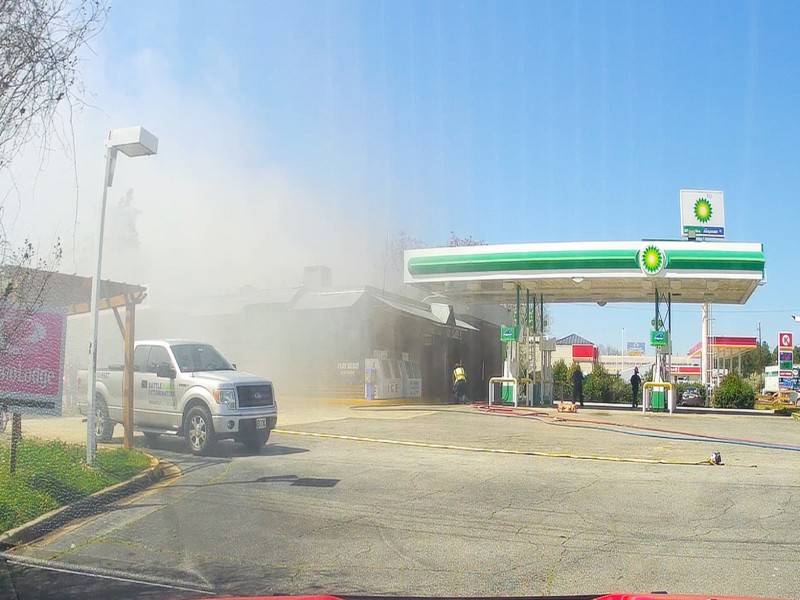 White smoke covering a building. A fire truck is seen.