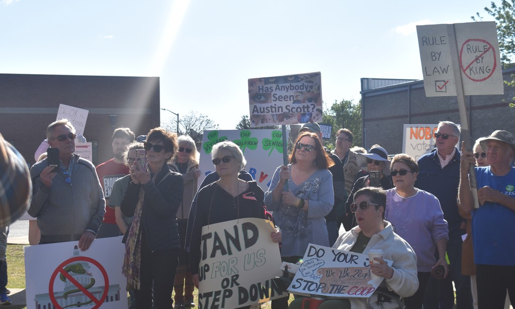 A group of people holding signs.