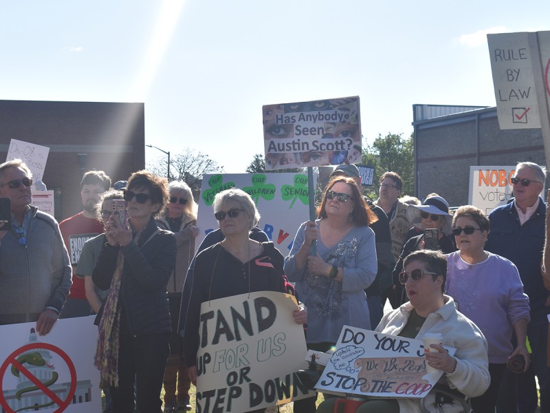 A group of people holding signs.