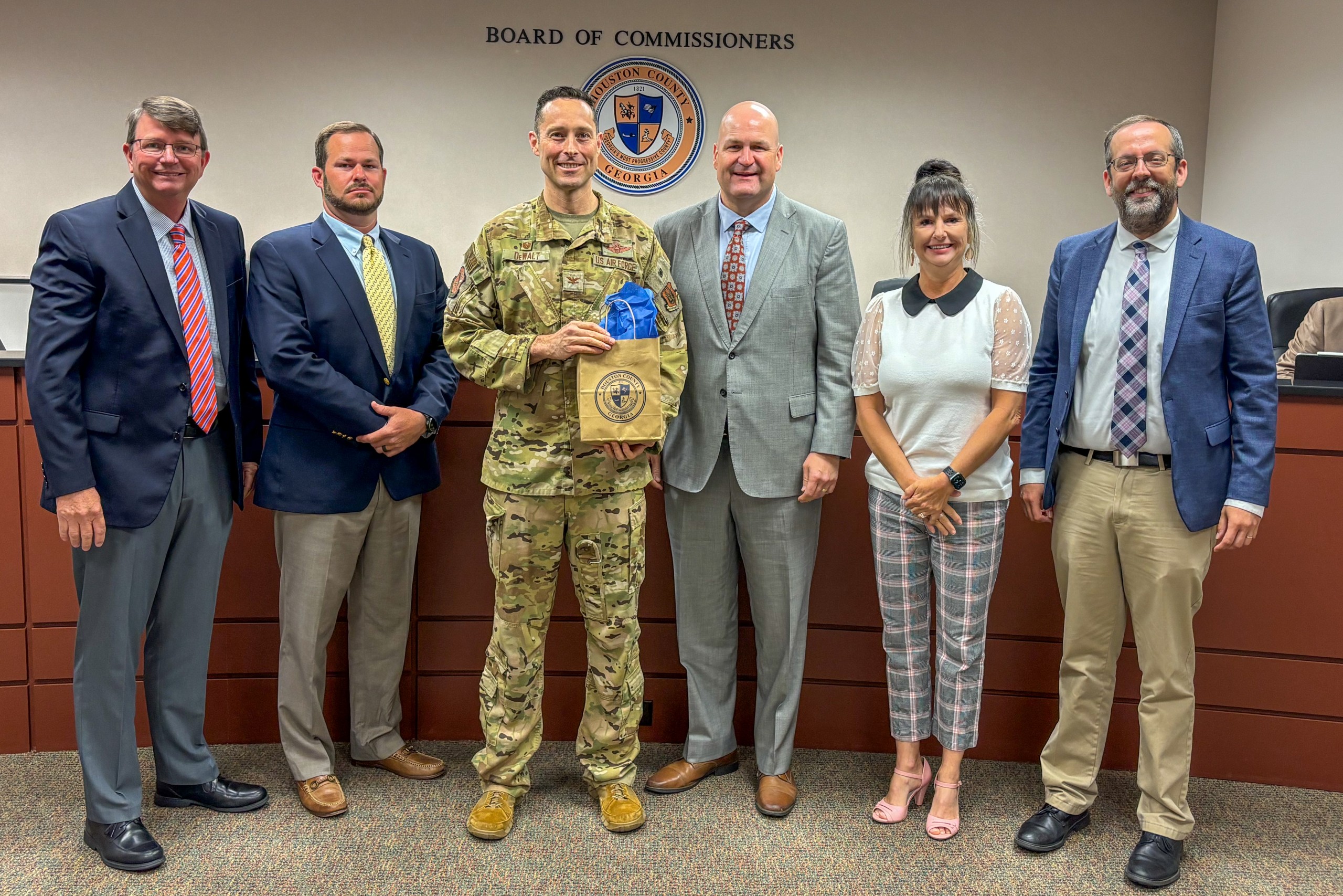 five men, one woman, man third from left wearing Air Force Uniform