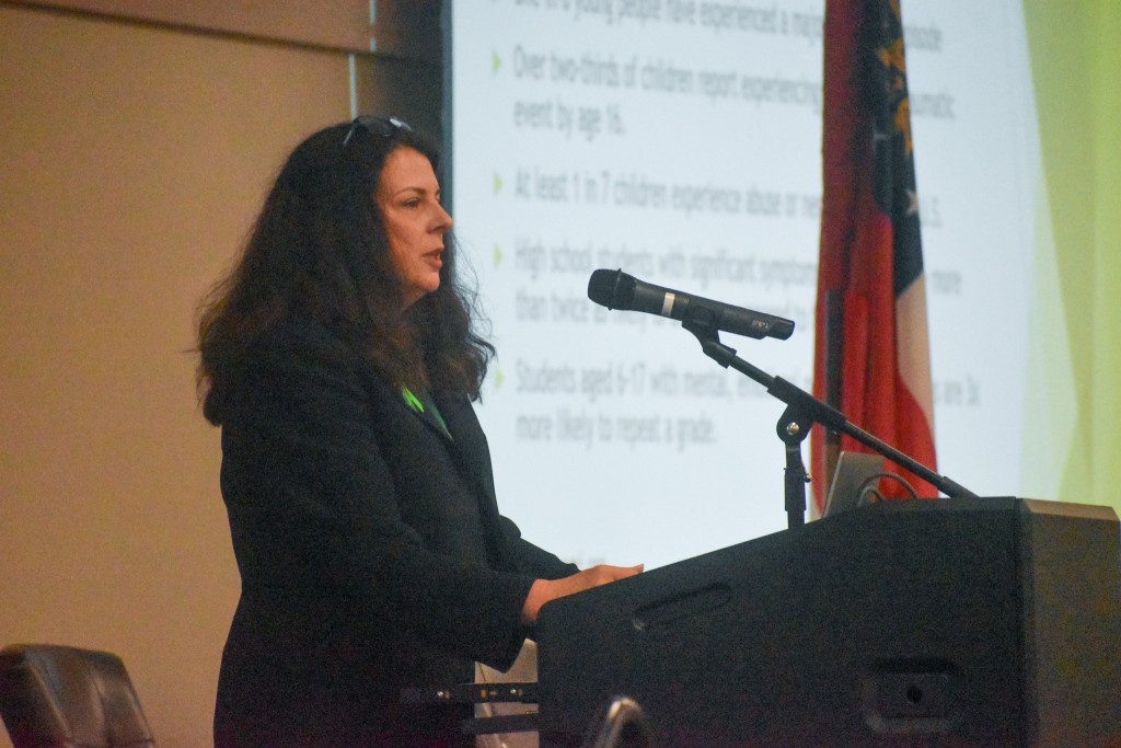 A women standing at a podium.