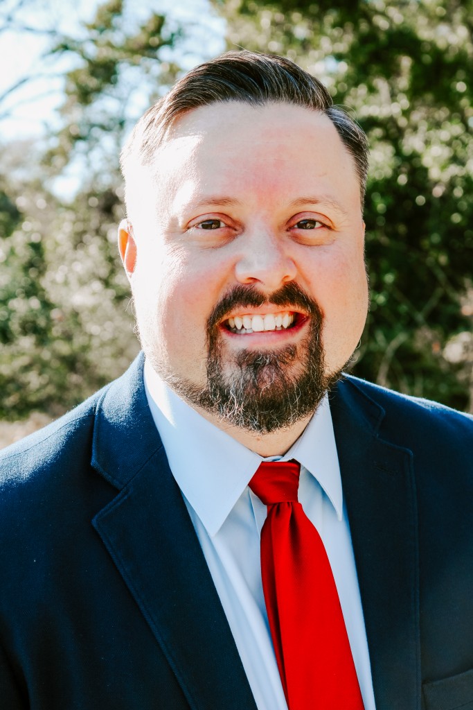 A man in a suit with a red tie.