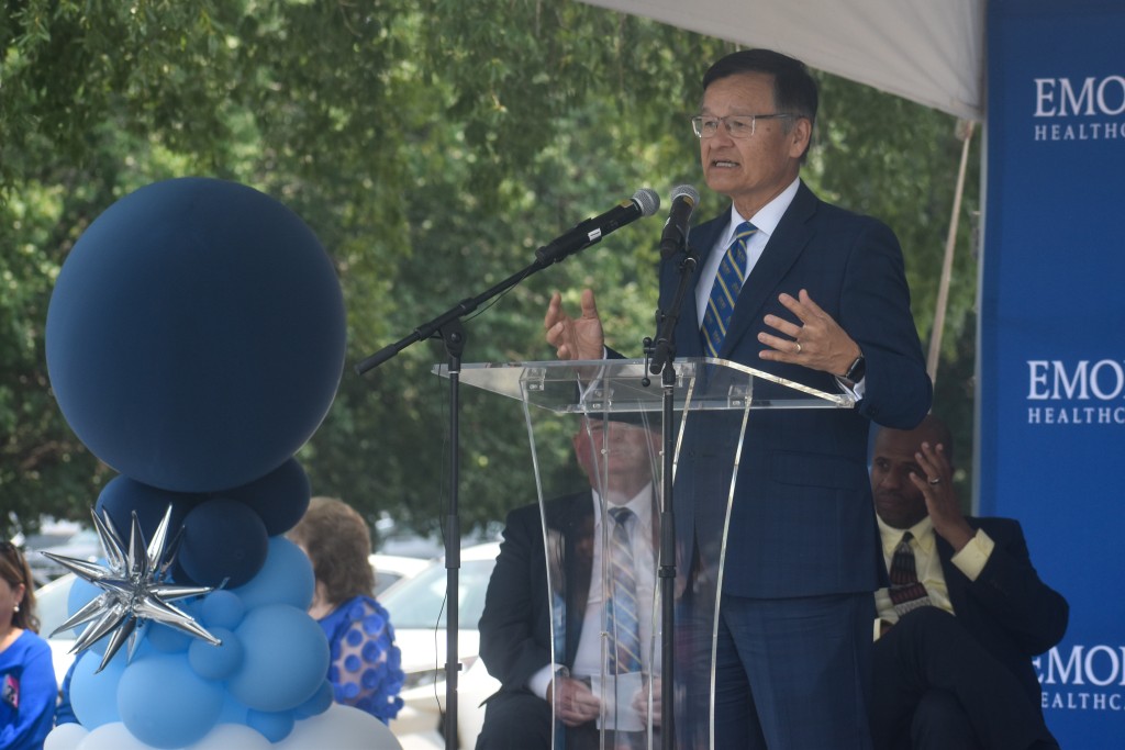 A man speaking behind a podium.