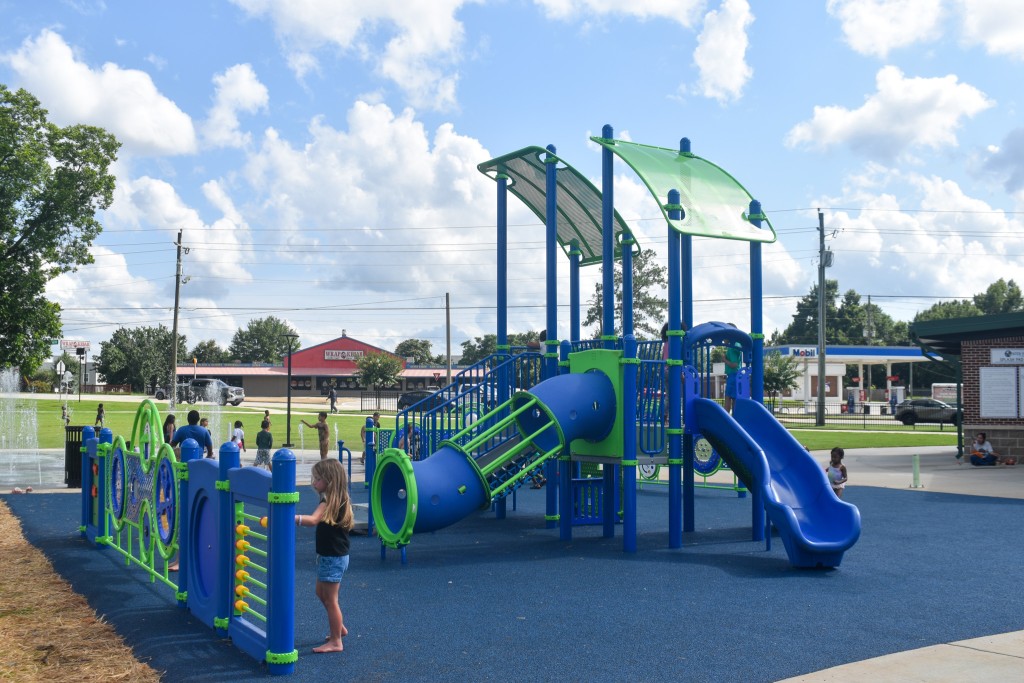 A blue and green playground. A slide is seen in the photo.