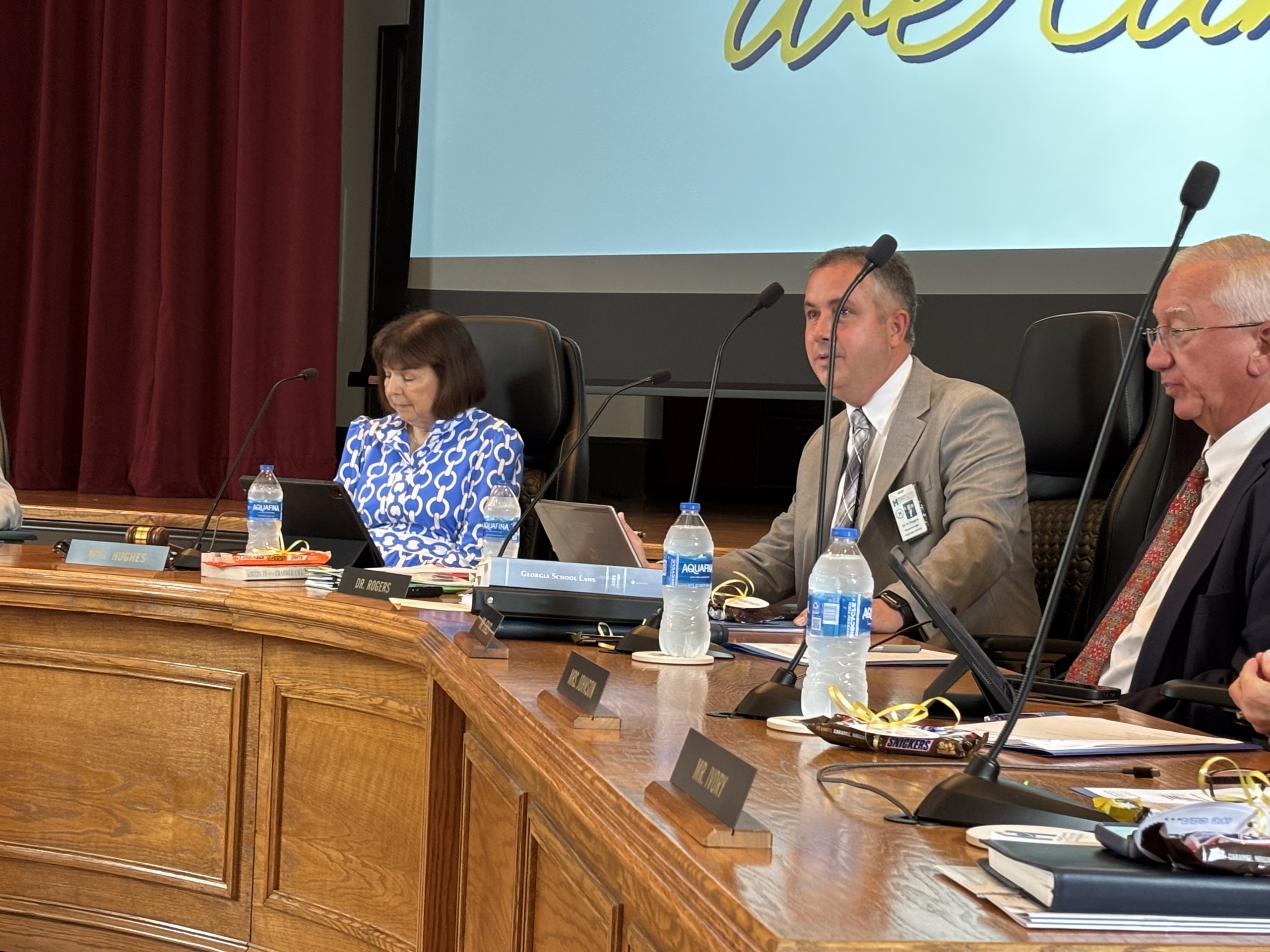 Board desk with three members of Houston County Board of Education