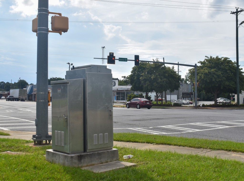 A silver box. In the background, a traffic signal is seen.