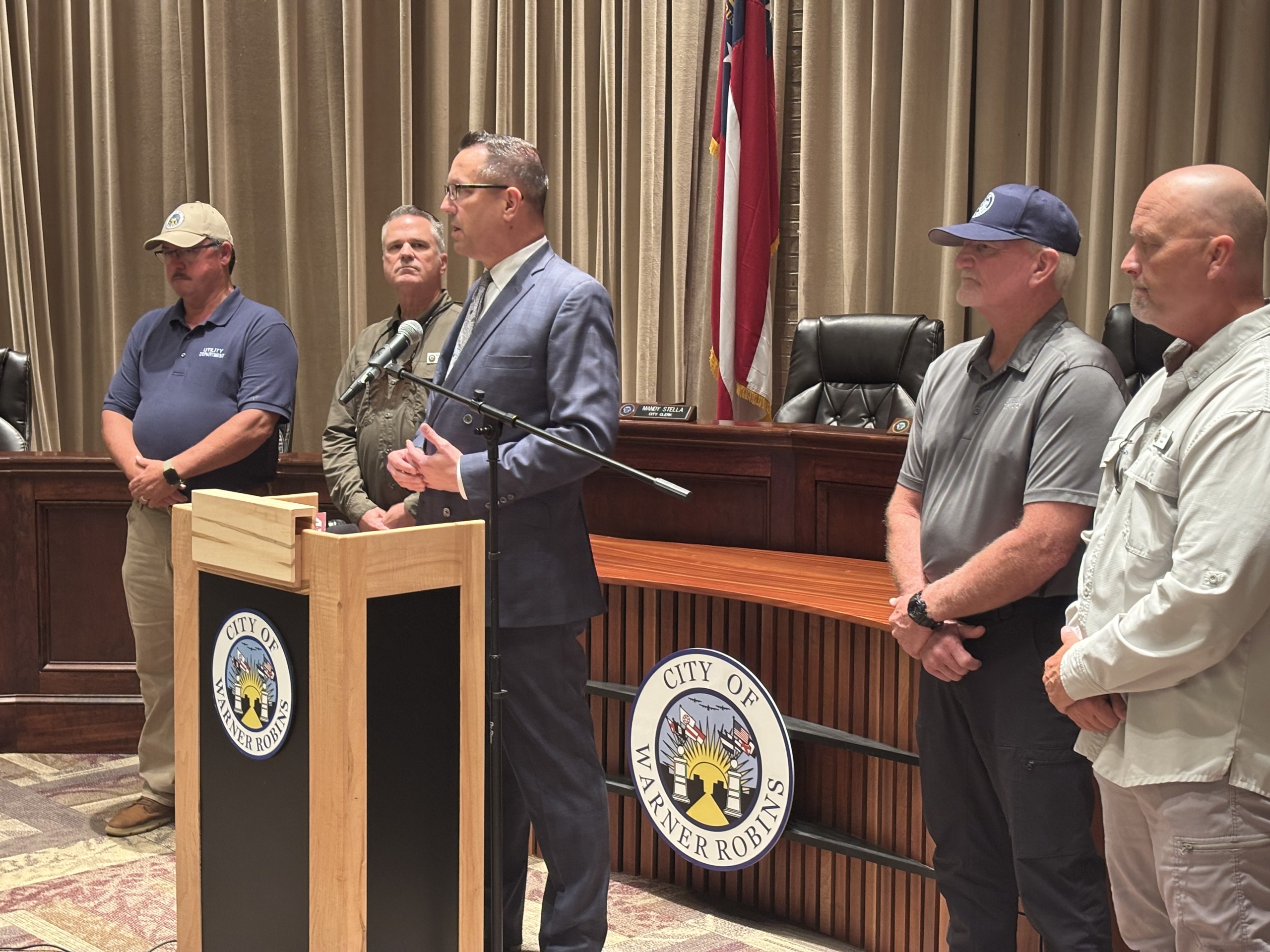 City of Warner Robins officials stand near a podium