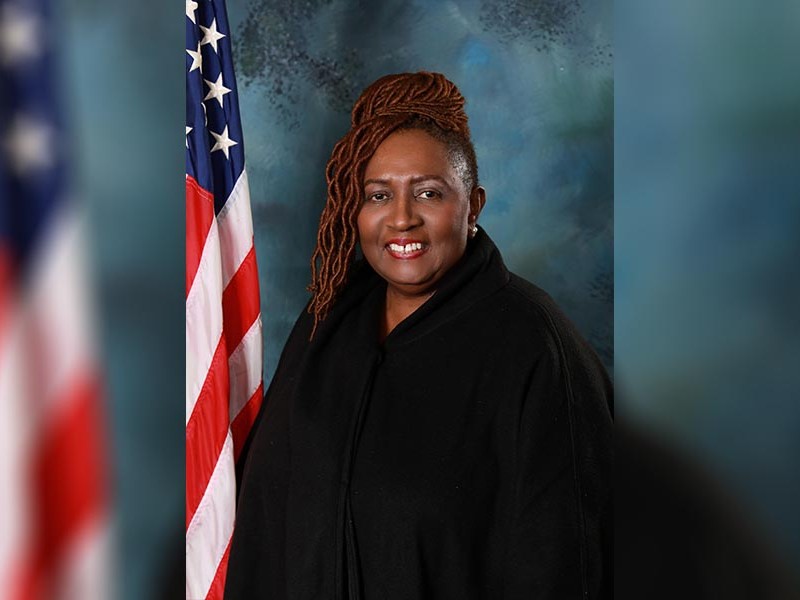 An African-American women in a black shirt smiling