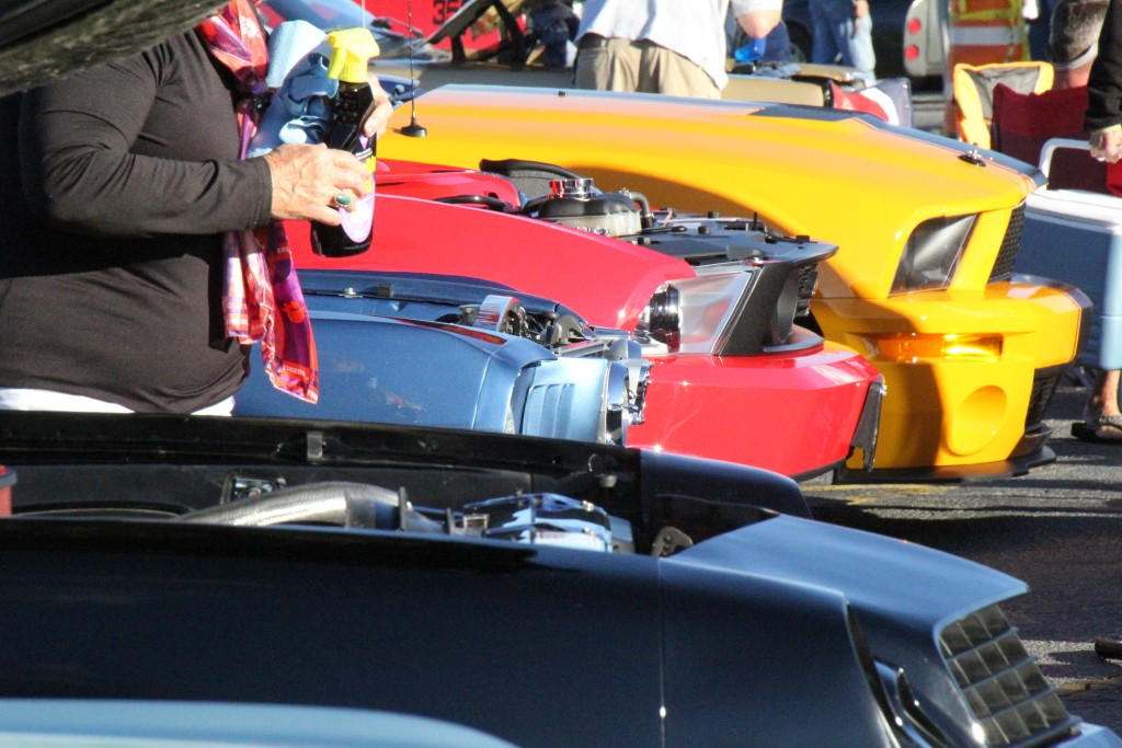 A black, red and yellow cars lined up.