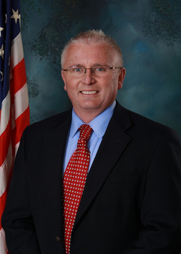 A man in a suit smiling