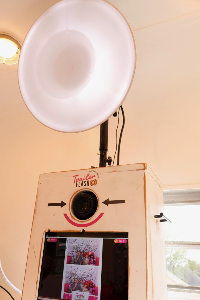 A white box with a flash. There is a screen on the box. 