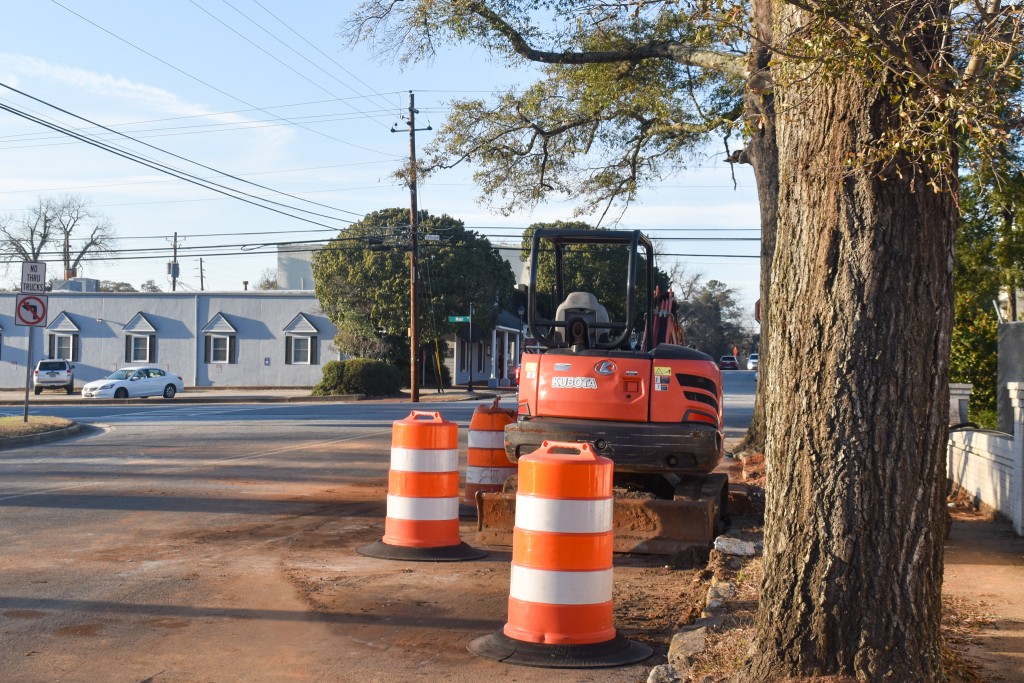 Orange and white cones on a street.