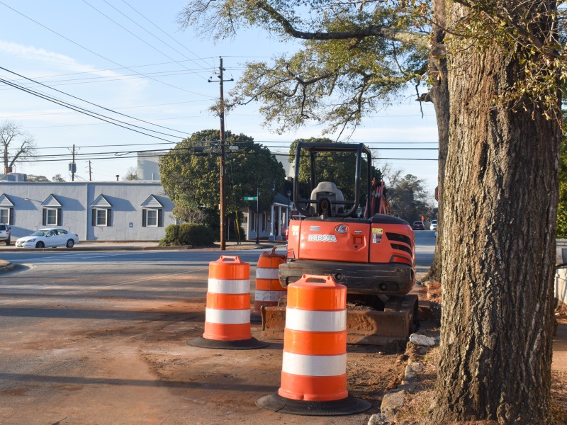 Orange and white cones on a street.
