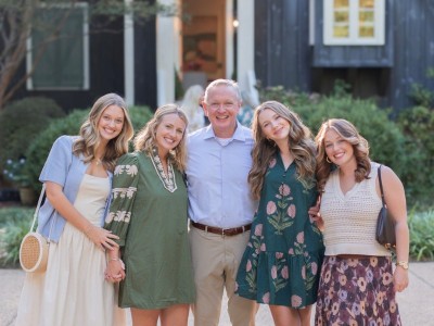 A family of five smiling.