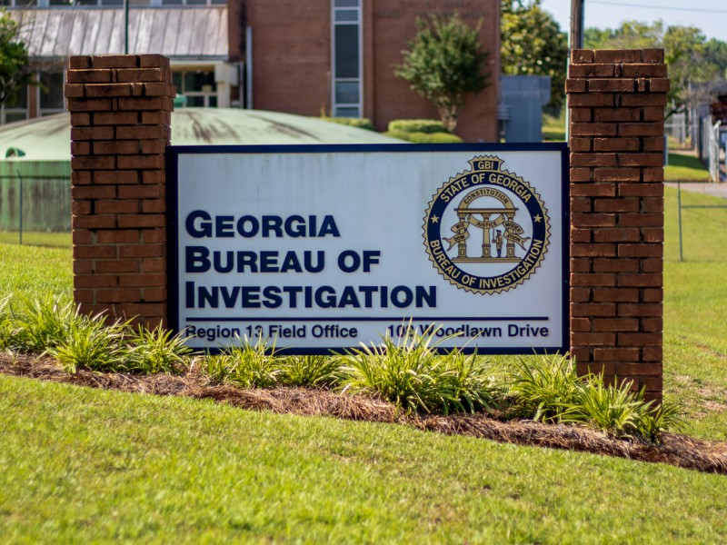 A brick sign that says "Georgia Bureau of Investigation" in black lettering on a white background.
