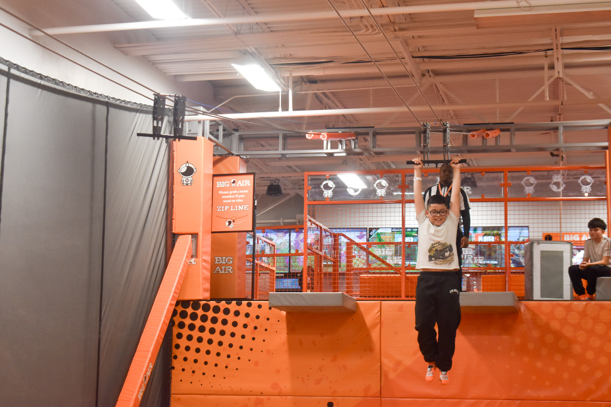A boy going down a zipline. 