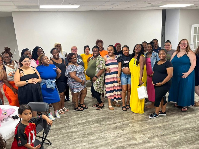A group of women standing together and smiling.